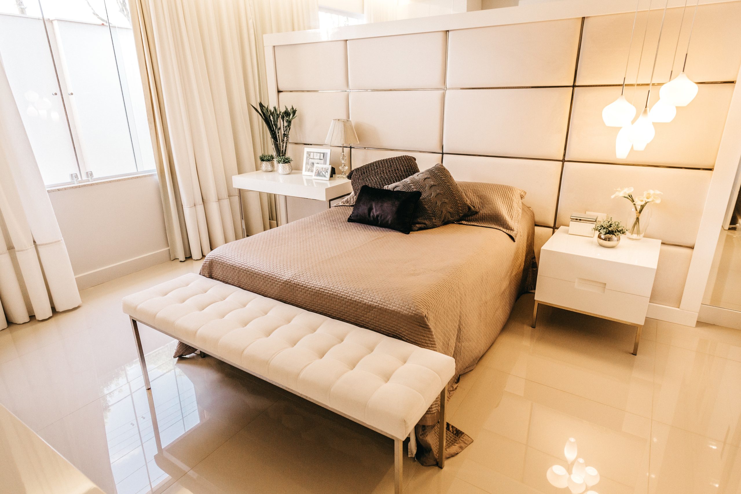 A high angle shot of a bedroom with interior stuff in beige tones